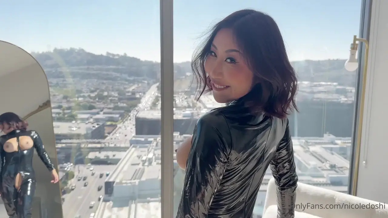 Nicole Doshi Gets Stretched In Her Latex Suit